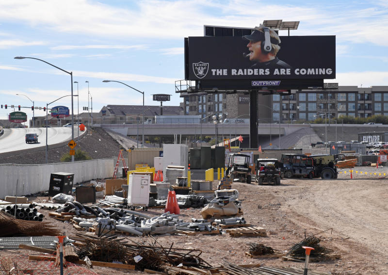 A billboard featuring the words "THE RAIDERS ARE COMING" and an image of Oakland Raiders head coach Jon Gruden is seen on the construction site of the Raiders' new stadium. (Getty Images)