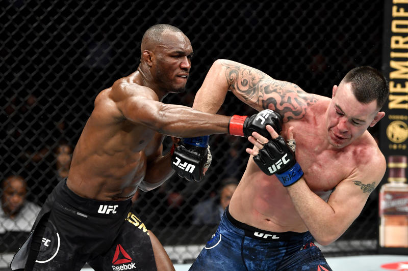 LAS VEGAS, NEVADA - DECEMBER 14: (L-R) Kamaru Usman of Nigeria strikes Colby Covington in their UFC welterweight championship bout during the UFC 245 event at T-Mobile Arena on December 14, 2019 in Las Vegas, Nevada. (Photo by Jeff Bottari/Zuffa LLC via Getty Images)