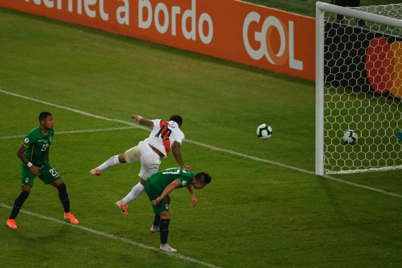 Peru&#39;s Jefferson Farfan (center) jumps over Bolivia&#39;s Marvin Bejarano to head home the decisive goal at the Copa America