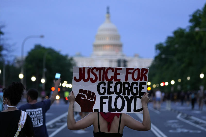 Demonstrators walk along Pennsylvania Avenue as they protest the death of George Floyd, a black man who died in police custody in Minneapolis, Friday, May 29, 2020, in Washington. (AP Photo/Evan Vucci)