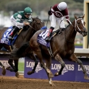 Rosie Napravnik, right, rides Untapable to victory ahead of Joseph Talamo on Iotapa in the Breeders' Cup Distaff horse race at Santa Anita on Friday, Oct. 31, 2014, in Arcadia, Calif. (AP Photo/Jae C. Hong)