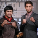 FILE - In this Aug. 25, 2014, file photo, WBO Welterweight champion Manny Pacquiao, left, of the Philippines, and WBO junior welterweight champion Chris Algieri of United States, right, pose for photographers during a news conference in Macau. the boxers are scheduled to meet in a title fight on Nov. 23, in Macau. (AP Photo/Vincent Yu, File)