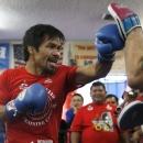 Boxer Manny Pacquiao (L) works out with his trainer Freddie Roach ahead of his bout with Tim Bradley, in Hollywood, Los Angeles, California, United States, March 30, 2016. REUTERS/Lucy Nicholson