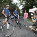 Lance Armstrong, left, stops along with other riders riders during the charity ride 