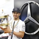 Mercedes Formula One driver Lewis Hamilton of Britain celebrates winning the Bahrain Grand Prix with the trophy in Sakhir April 19, 2015. Action Images via Reuters / Hoch Zwei Livepic