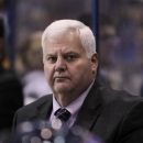 FILE - In this Sept. 30, 2014 file photo, St. Louis Blues head coach Ken Hitchcock watches the action from the bench during the third period of a preseason NHL hockey game against the Carolina Hurricanes in St. Louis. The St. Louis Blues are sticking with Hitchcock for another season, announcing Tuesday, May 26, 2015, the veteran coach has signed a one-year contract. (AP Photo/Tom Gannam, FILE)