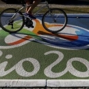 A woman rides her bicycle as she passes over a newly-painted bicyle lane ahead of the Rio 2016 Olympic games near Barra da Tijuca beach in Rio de Janeiro, Brazil, July 27, 2016.  REUTERS/Sergio Moraes