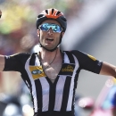 Britain's Stephen Cummings, wearing an orange helmet to mark Nelson Mandela's birthday, celebrates a she crosses the finish line to win the fourteenth stage of the Tour de France cycling race over 178.5 kilometers (110.9 miles) with start in Rodez and finish in Mende, France, Saturday, July 18, 2015. (AP Photo/Peter Dejong)