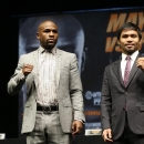 Floyd Mayweather (L) and Manny Pacquiao pose together at the end of their press conference promoting their upcoming fight on March 11, 2015 in Los Angeles, California (AFP Photo/Stephen Dunn)