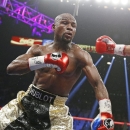 Manny Pacquiao, from the Philippines, right, throws a right against Floyd Mayweather Jr., during their welterweight title fight on Saturday, May 2, 2015 in Las Vegas. (AP Photo/John Locher)