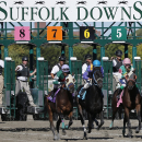 FILE - In this Sept. 22, 2014 file photo, gate crew members watch the start of a race at Suffolk Downs in Boston. The track will mark what's likely the final day of thoroughbred racing at the 79-year-old course on Saturday, Oct. 4, 2014, with a series of tributes featuring the horses and the people who made it famous. (AP Photo/Elise Amendola, File)