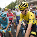 Britain's Chris Froome, wearing the overall leader's yellow jersey, arrives to take his place in the pack prior to the start of the fourteenth stage of the Tour de France cycling race over 178.5 kilometers (110.9 miles) with start in Rodez and finish in Mende, France, Saturday, July 18, 2015. (AP Photo/Laurent Cipriani)