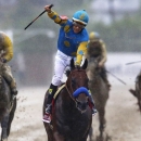 FILE - In this May 16, 2015, file photo, jockey Victor Espinoza, center, celebrates aboard American Pharoah after winning the 140th Preakness Stakes horse race at Pimlico Race Course in Baltimore. Last June, Espinoza was aboard California Chrome during his Triple Crown run that ended with a fourth-place finish in the Belmont. In 2002, he and trainer Bob Baffert teamed up with War Emblem to win the Kentucky Derby and Preakness before their Triple try ended when the colt stumbled out of the starting gate in the Belmont and finished eighth. Now, Espinoza and Baffert are back again with a colt many believed is poised to become the 12th Triple Crown winner and first since Affirmed in 1978. (AP Photo/Patrick Semansky, File)