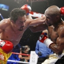 Floyd Mayweather Jr. (R) battles Manny Pacquiao on May 2 in a fight that sold a record 4.4 million pay-per-views. (AP Photo/John Locher)