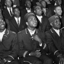 FILE - In this Feb. 28, 1966 file photo, Muhammad Ali listens to Elijah Muhammad as he speaks to other black Muslims in Chicago. Two days after the 1964 fight with Sonny Liston, Cassius Clay announced he was a member of the Nation of Islam and was changing his name to Cassius X. He would later become Muhammad Ali as he broke away from Malcom X and aligned himself with the sect's leader, Elijiah Muhammad. 