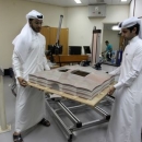 Mechanical engineers Abdullah Mojeb Aldar (L), 26, and Fahad al-Musalam, 24, move a 3d-printed model of QatarÕs Al Bayt stadium, which will host a World Cup semi-final in 2022, at a laboratory at Qatar University in Doha, Qatar June 16, 2016. REUTERS/Ibraheem Al Omari