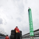 The crew for Sebastian Saavedra, of Colombia, carries tires back to the garage during practice for the Indianapolis 500 auto race at Indianapolis Motor Speedway in Indianapolis, Monday, May 11, 2015. (AP Photo/Darron Cummings)