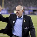 Former New York Giants coach Tom Coughlin waves to fans as he walks on the field before an NFL football game between the New York Giants and the Cincinnati Bengals, Monday, Nov. 14, 2016, in East Rutherford, N.J. (AP Photo/Bill Kostroun)