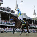 FILE - In this May 2, 2015 file photo, jockey Victor Espinoza celebrates aboard American Pharoah after winning the 141st running of the Kentucky Derby horse race at Churchill Downs in Louisville, Ky. (AP Photo/David J. Phillip, File)