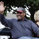 FILE - In this June 12, 2011, file photo, former heavyweight boxing champion Leon Spinks waves during a Boxing Hall of Fame parade in Canastota, N.Y. Leon Spinks is in a Las Vegas hospital after a second operation for abdominal problems. The 61-year-old boxer who catapulted to fame by beating Muhammad Ali in 1978 had the second surgery in recent days after complications from the first emergency surgery. (AP Photo/Mike Groll, File)