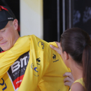 Australia's Rohan Dennis puts on the overall leader's yellow jersey on the podium of the first stage of the Tour de France cycling race, an individual time trial over 13.8 kilometers (8.57 miles), with start and Finish in Utrecht, Netherlands, Saturday, July 4, 2015. (AP Photo/Christophe Ena)