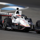 Will Power, of Australia, drives through a turn during practice for the Grand Prix of Indianapolis auto race at the Indianapolis Motor Speedway in Indianapolis, Friday, May 8, 2015. (AP Photo/Michael Conroy)