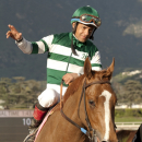 In a photo provided by Benoit Photo, jockey Victor Espinoza waves aas Stellar Wind is guided into the winner's circle after their victory in the $100,000 Santa Ysabel Stakes horse race, Saturday, Feb. 28, 2015, at Santa Anita in Arcadia, Calif. (AP Photo/Benoit Photo)