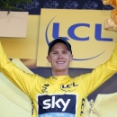 Team Sky rider Chris Froome of Britain celebrates as he wears the race leader's yellow jersey on the podium of the third stage of the 102nd Tour de France cycling race from Anvers to Huy, July 6, 2015.  REUTERS/Eric Gaillard