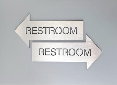 restroom sign with arrow