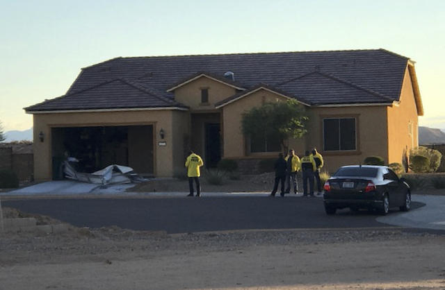 Police personnel stand outside the home of Stephen Paddock 