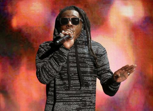 FILE - In this Nov. 23, 2014 file photo, Lil Wayne performs on stage at the 42nd annual American Music Awards in Los Angeles. The is rapper suing the record label Cash Money in New York for $51 million after claiming that it stiffed him for $8 million on a record he delivered. In the federal lawsuit filed Wednesday, Lil Wayne’s asking to nullify contracts with the company. The New Orleans-born Lil Wayne says his relationship with the label has been deteriorating over the last four years. (Photo by Matt Sayles/Invision/AP, FIle)