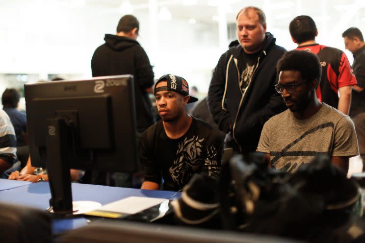 Kyle 'KyleP' Palsson (background) watches Kevin 'Dieminion' Landon and Julian 'Squall' Jones play casuals