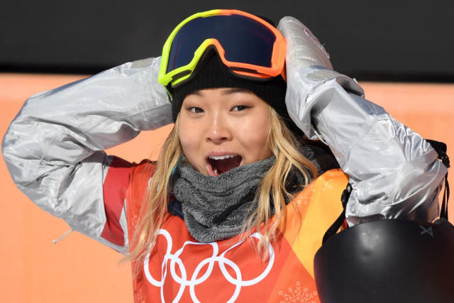 Chloe Kim celebrates after her first run in the finals of the women’s halfpipe. (Getty)