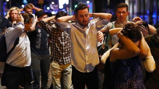 PHOTO: People leave the area with their hands up after an incident near London Bridge in London, June 4, 2017. (Neil Hall/Reuters)