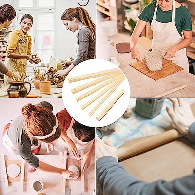 Rolled Piece Of Pottery Clay With A Wooden Rolling Pin On A Board