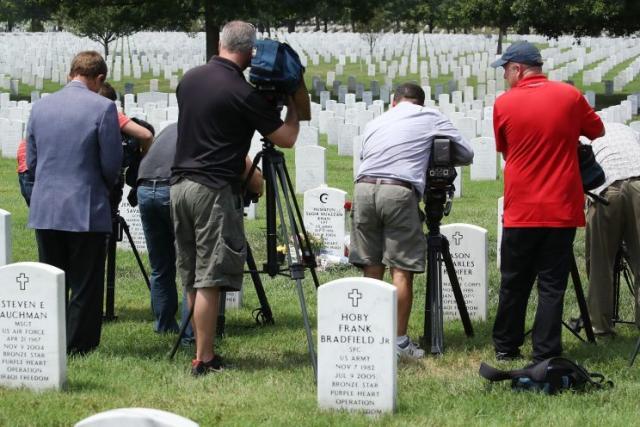 Members of the media photograph the tombstone of Capt. Humayun Khan at Arlington National Cemetery. (Photo: Mark Wilson/Getty Images)