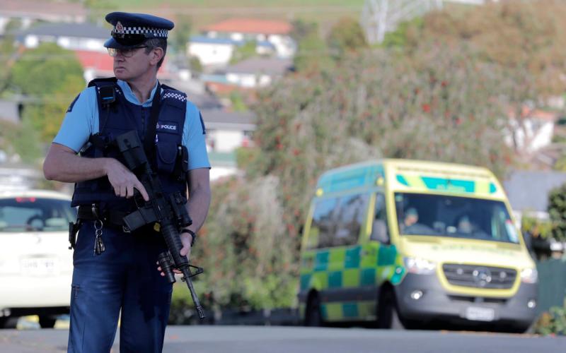 Armed police stands at the scene of a shooting incident following a routine traffic stop in Auckland, New Zealand - New Zealand Herald