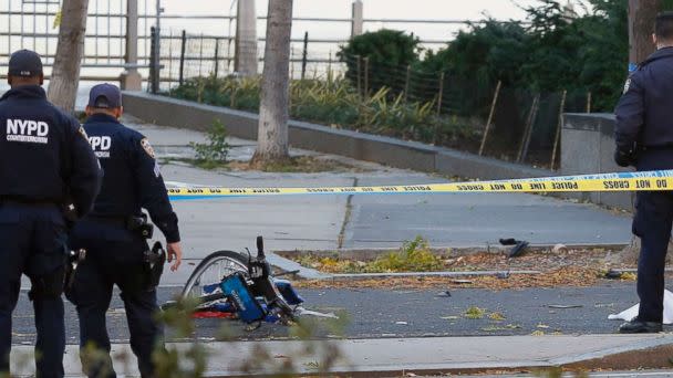 PHOTO: A New York Police Department officer stands next to a body covered under a white sheet near a mangled bike along a bike path, Oct. 31, 2017, in New York. (Bebeto Matthews/AP)