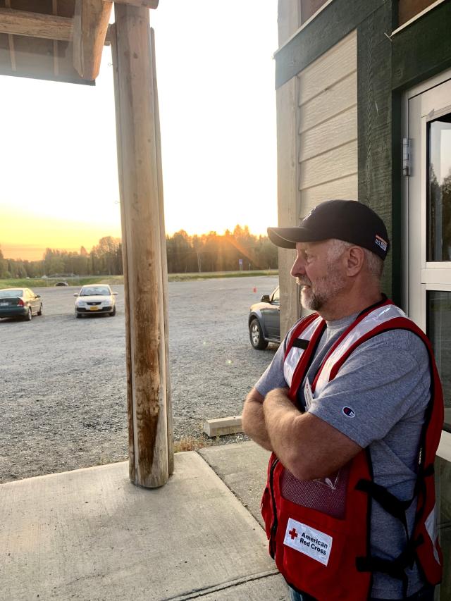 Red Cross volunteer and retired educator Matt Clark awaits evacuees of the McKinley Fire at the Upper Susitna Senior Center in Sunshine, Alaska, as the sun set Saturday night.