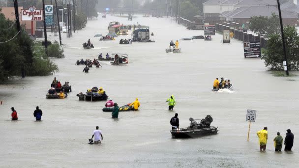 PHOTO: Rescue boats fill a flooded street at flood victims are evacuated as floodwaters from Harvey rise, Aug. 28, 2017, in Houston. (David J. Phillip/AP)