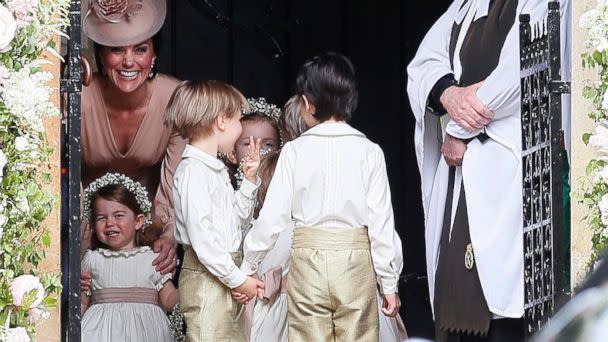 PHOTO: Kate, Duchess of Cambridge, left, stands with her daughter Princess Charlotte, bottom left, as they arrive for the wedding of Pippa Middleton and James Matthews at St Mark's Church in Englefield, May 20, 2017. (Kirsty Wigglesworth/AP)