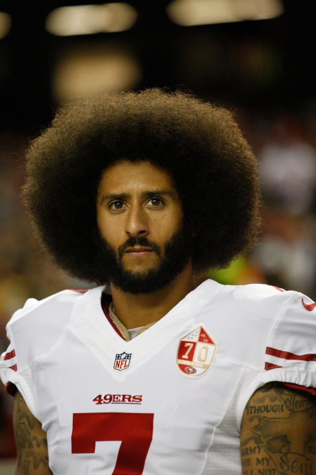 Colin Kaepernick stands on the sideline during the game between the San Francisco 49ers and the Atlanta Falcons at the Georgia Dome on Dec. 18, 2016 in Atlanta.