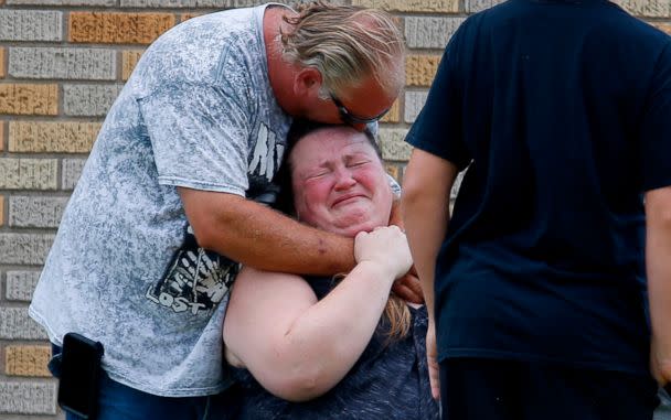 PHOTO: A man hugs a woman outside the Alamo Gym where parents wait to reunite with their children following a shooting at Santa Fe High School in Santa Fe, Texas, May 18, 2018. (Michael Ciaglo/Houston Chronicle via AP)