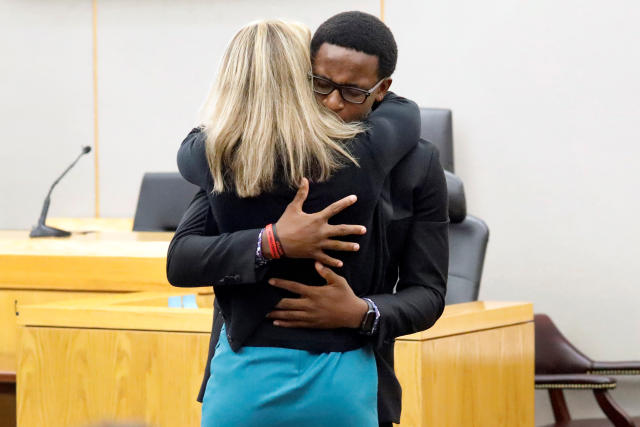 Botham Jean's younger brother Brandt Jean hugs former Dallas police officer Amber Guyger after delivering his impact statement to her following her 10-year prison sentence for murder at the Frank Crowley Courts Building in Dallas, Texas, U.S. October 2, 2019. Tom Fox/Pool via REUTERS MANDATORY CREDIT