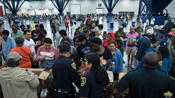 PHOTO: Flood victims gather for food at a shelter in the George R. Brown Convention Center during the aftermath of Hurricane Harvey, August 28, 2017, in Houston, Texas. (Brendan Smialowski/AFP/Getty Images)