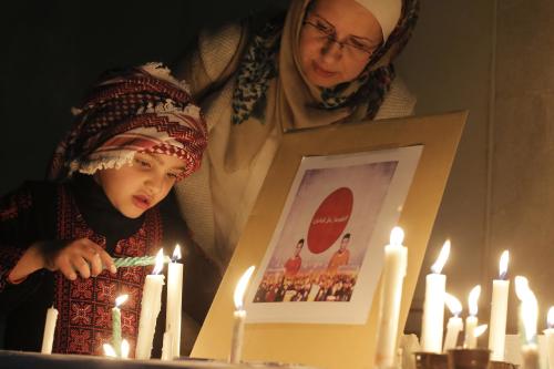 Jordanians take part in a candlelight vigil to condemn the killings of Haruna Yukawa and Kenji Goto by the Islamic State group outside the Japanese embassy in Amman on February 2, 2015