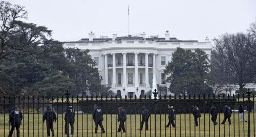 Secret Service officers search the south grounds of the White House in Washington, Monday, Jan. 26, 2015. A device, possibly an unmanned aerial drone, was found on the White House grounds during the middle of the night while President Barack Obama and the first lady were in India, but his spokesman said Monday that it posed no threat. (AP Photo/Susan Walsh)