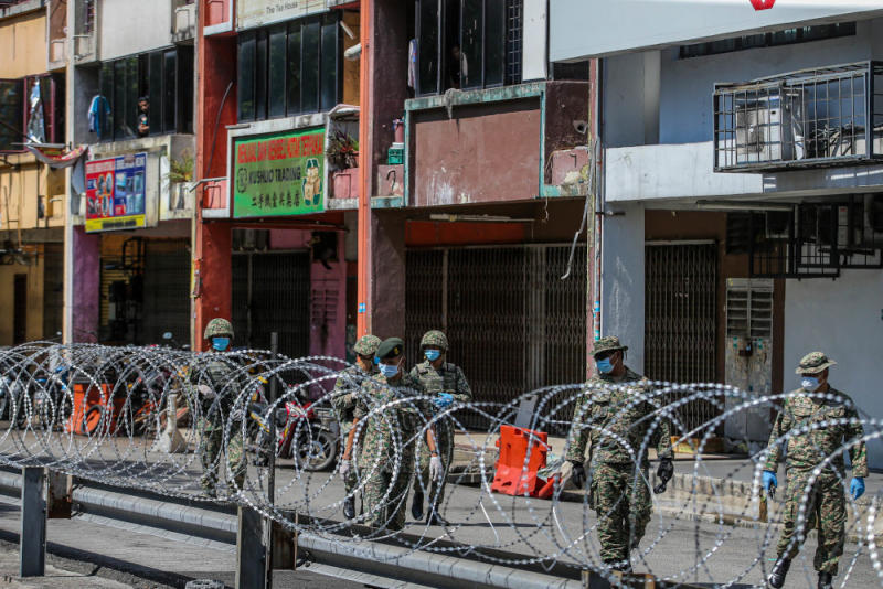 Armed Forces personnel patrol the locked down area of the Selayang wholesale market in Kuala Lumpur April, 21 April 2020. — Picture by Hari Anggara