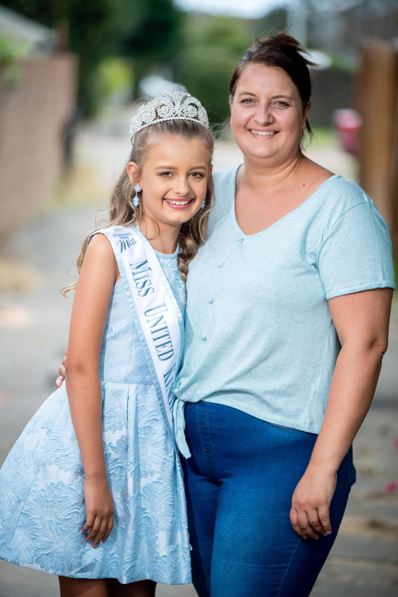 Mum and beauty queen daughter with crown on