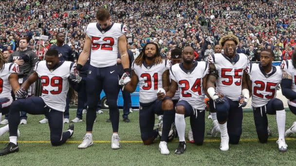 PHOTO: Houston Texans players kneel and stand during the singing of the national anthem before an NFL football game against the Seattle Seahawks, Oct. 29, 2017, in Seattle. (Elaine Thompson/AP)